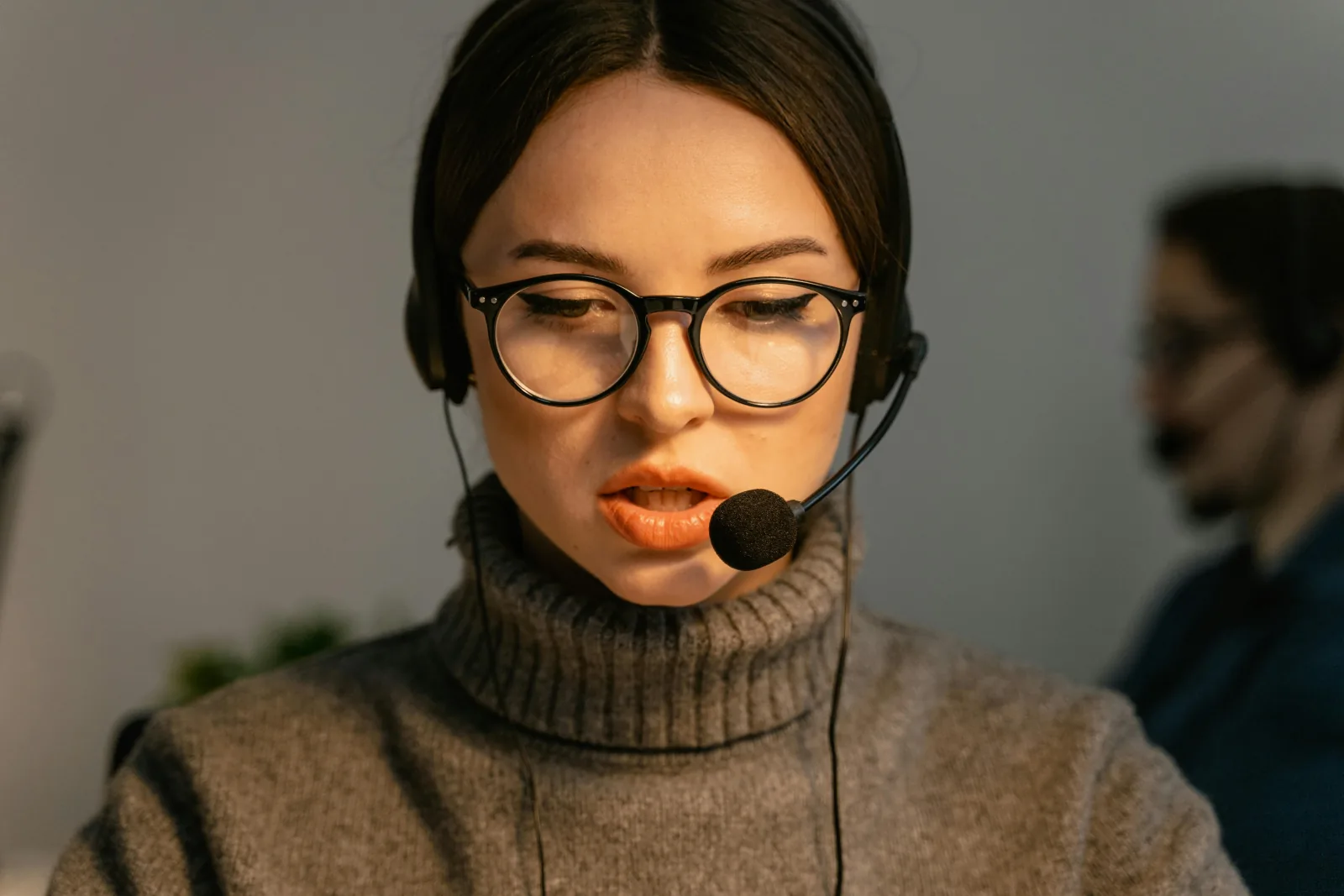Operator wearing a headset at a desk